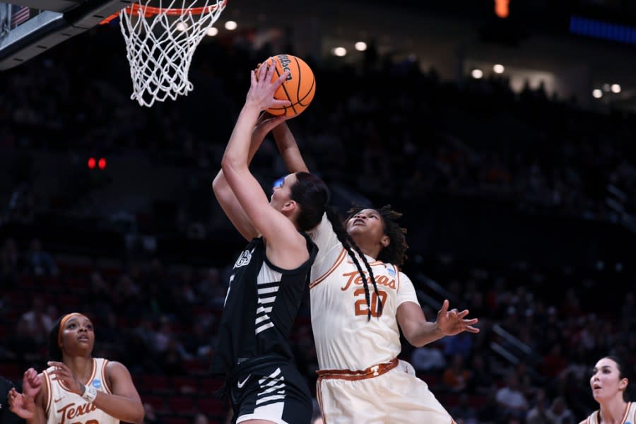 Gonzaga forward Maud Huijbens, center left, shoots as Texas forward Maud Huijbens (20) defends during the first half of a Sweet 16 college basketball game in the women’s NCAA Tournament, Friday, March 29, 2024, in Portland, Ore. (AP Photo/Howard Lao)