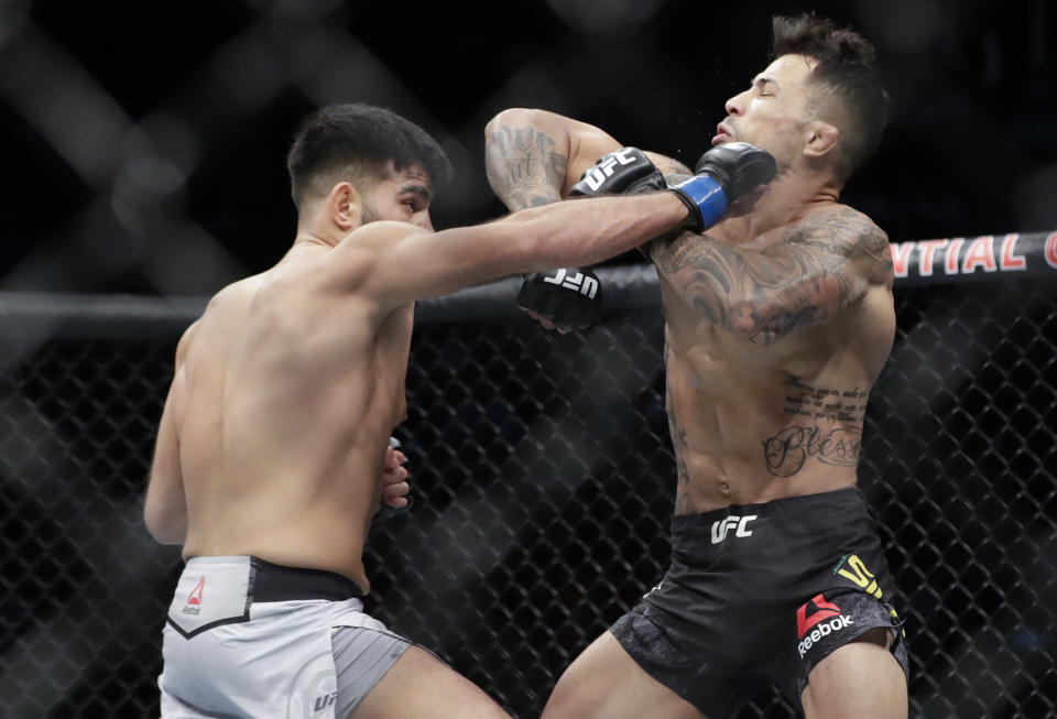 Germany's Nasrat Haqparast, left, punches Brazil's Joaquim Silva during the first round of a lightweight mixed martial arts bout at UFC Fight Night Saturday, Aug. 3, 2019, in Newark, N.J. Haqparast stopped Silva in the second round. (AP Photo/Frank Franklin II)