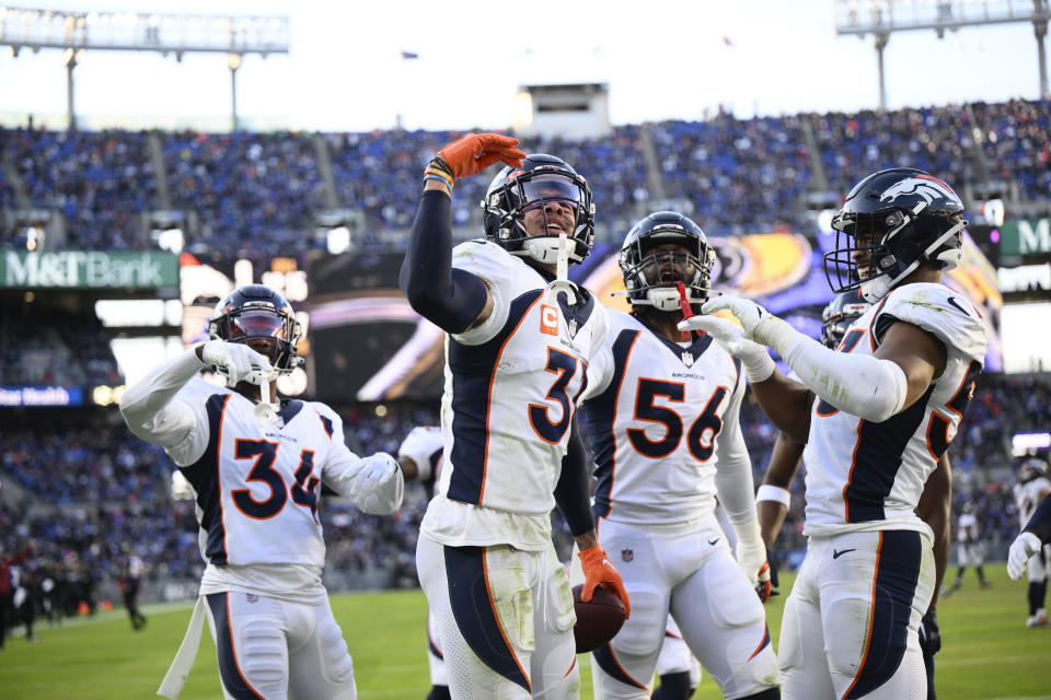 Denver Broncos safety Justin Simmons (31) celebrates with teammates after intercepting a Baltimore Ravens pass in the end zone in the second half of an NFL football game, Sunday, Dec. 4, 2022, in Baltimore. (AP Photo/Nick Wass)