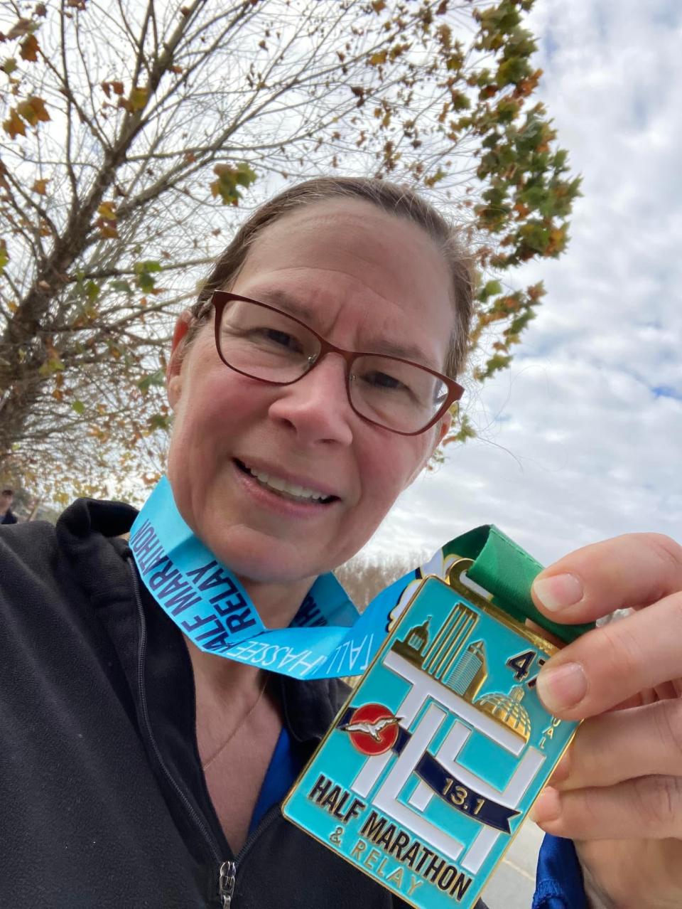 Ella Schwarz with her medal from the 2022 Tallahassee Half Marathon.