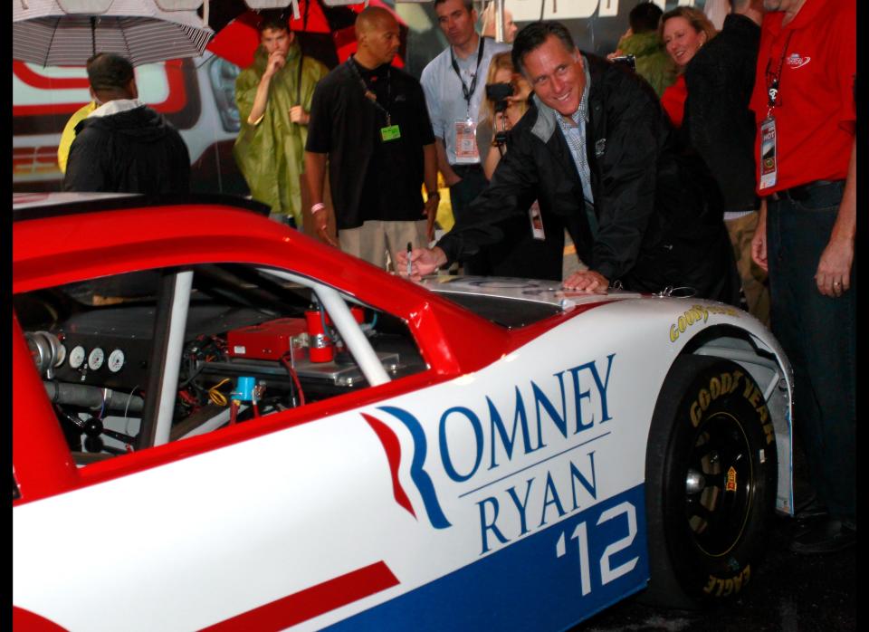 RICHMOND, VA - SEPTEMBER 08:  Republican presidential candidate, former Massachusetts Gov. Mitt Romney signs a car with a Romney/Ryan '12 logo in the garage area during a rain delay before the start of the NASCAR Sprint Cup Series Federated Auto Parts 400 at Richmond International Raceway on September 8, 2012 in Richmond, Virginia.  (Photo by Geoff Burke/Getty Images)