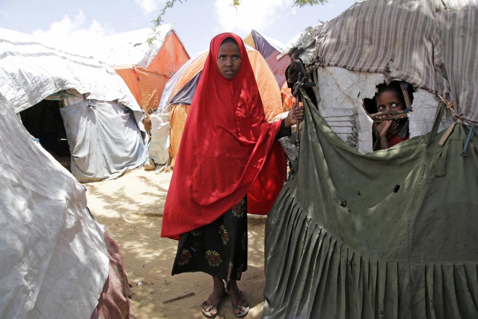 Shukri Mohamed Ibrahim, who fled amid a drought with her family, stands in makeshift camp for displaced people, on the outskirts of Mogadishu, Somalia on Thursday, Sept, 28, 2023. The worst drought in more than 50 years scorched the once-fertile pastures her family relied on, leaving them barren. (AP Photo/Farah Abdi Warsameh)