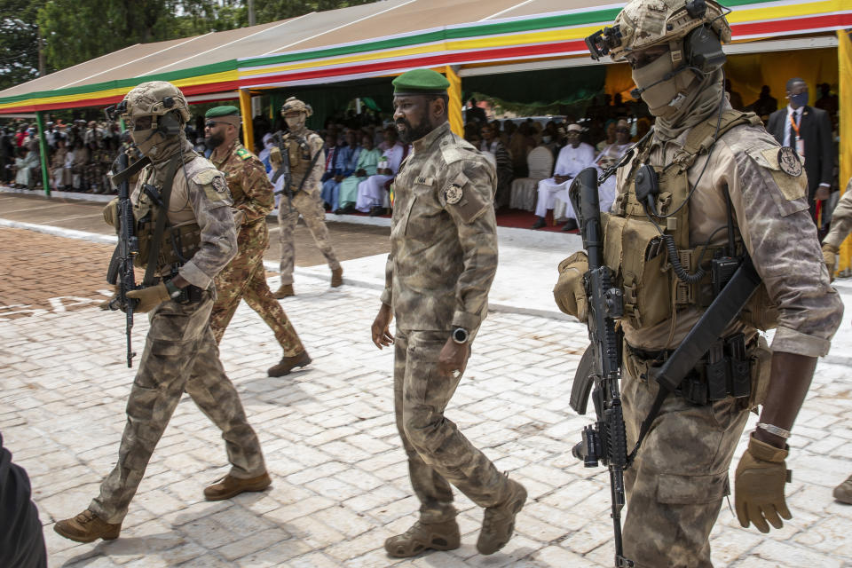 FILE - Leader of Mali's ruling junta Lt. Col. Assimi Goita, center, attends an independence day military parade in Bamako, Mali on Sept. 22, 2022. Malian voters cast ballots on a new draft constitution Sunday, June 18, 2023, in a referendum that the country's coup leader says will pave the way toward holding new elections in 2024, but that critics have called a delaying tactic. In a message broadcast on state television on the eve of the vote, Col. Assimi Goita told Malians that the proposed draft constitution “provides for a better-organized executive power, while maintaining the necessary balance with the legislative power.”. (AP Photo, File)