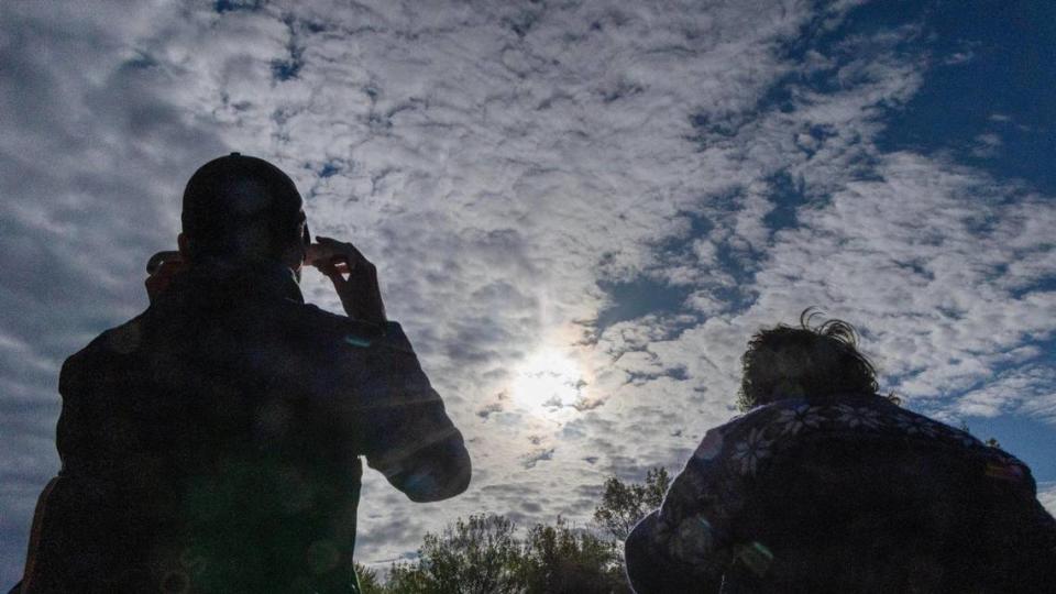 Attendees at a morning event held at Boise State University’s campus view the annular solar eclipse through filtered lens glasses, Saturday, Oct. 14, 2023. At its peak, Boise experienced 85% of the sun blocked by the moon.