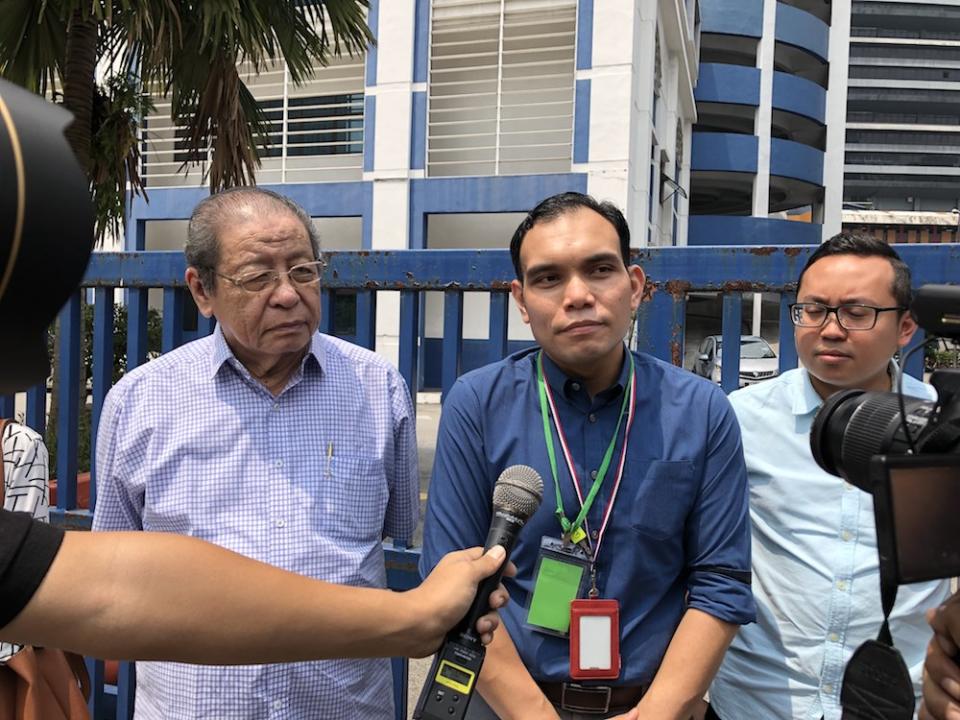 Syahredzan Johan, flanked by Lim Kit Siang, speaks to reporters after lodging a police report at the Dang Wangi district police headquarters August 15, 2019. — Picture by Emmanuel Santa Maria Chin