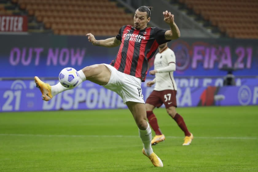 AC Milan's Zlatan Ibrahimovic scores his side's opening goal during the Serie A soccer match between AC Milan and Roma at the Milan San Siro Stadium, Italy, Monday, Oct. 26, 2020. (AP Photo/Luca Bruno)