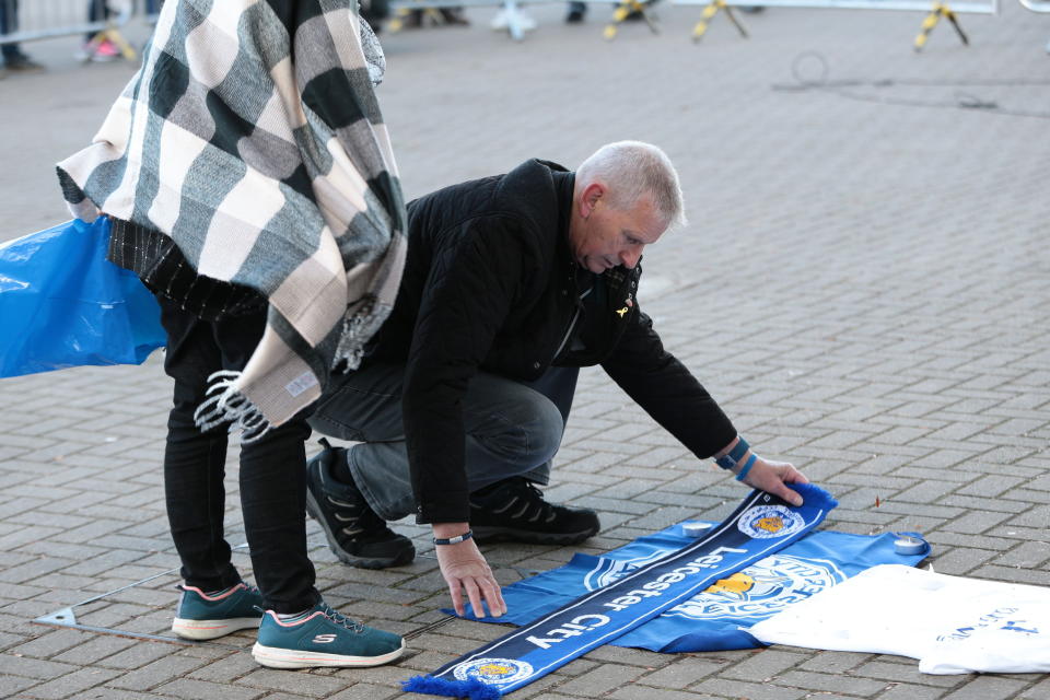 <p>Supporters lay tributes to the Leicester City owner after the crash which killed five people. Aaron Chown/PA Wire </p>
