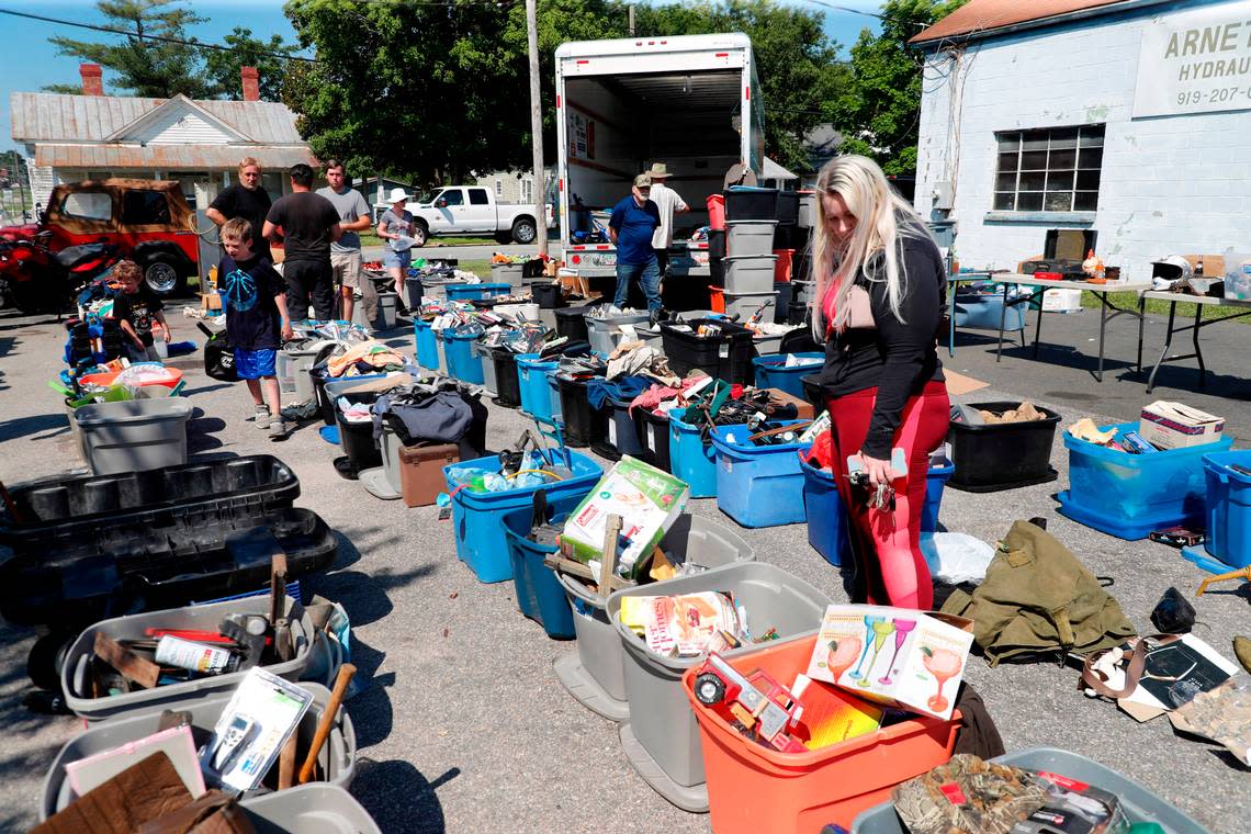 Shoppers look over items for a sale outside Arnett Hydraulics in Benson, N.C., Friday, June 18, 2021, part of the 301 Endless Yard Sale. The yearly yard sale has vendors setting up along the side of U.S. Hwy. 301 in five counties.