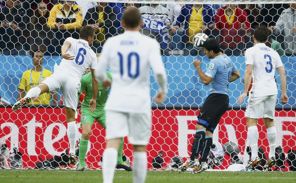 Uruguay's Suarez heads to score against England during their 2014 World Cup Group D soccer match at the Corinthians arena in Sao Paulo