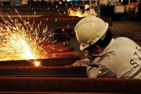 A worker welds at a marine petroleum platform in Qingdao, Shandong province, August 1, 2016. China Daily/via REUTERS