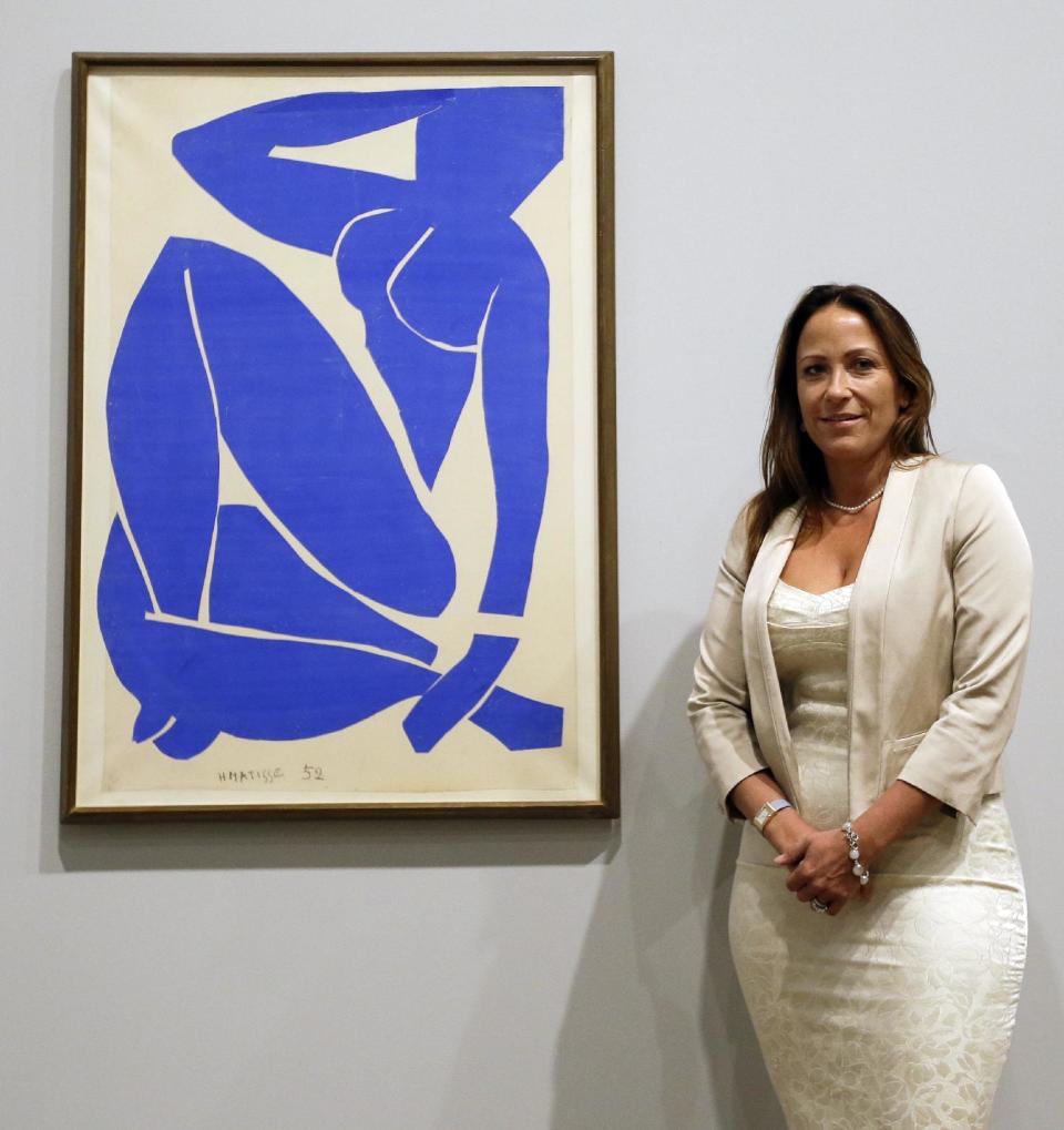 Sophie Matisse, the great-granddaughter of Henri Matisse, stands alongside his work 'Blue Nude III 1952' at The Tate Modern in London, Monday, April 14, 2014. The artworks are part of the 'Henri Matisse: The Cut-Outs' exhibition that runs at the gallery from April 17 until Sept. 7, 2014.(AP Photo/Kirsty Wigglesworth)