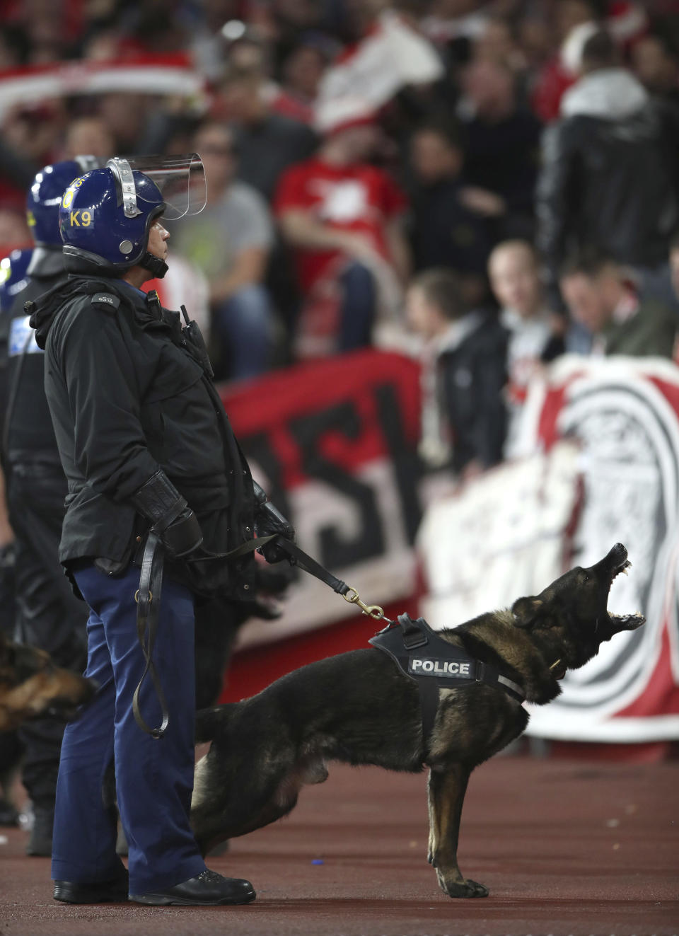 <p>Police with dogs keep watch over FC Koln fans during the Europa League match against Arsenal at the Emirates Stadium, London, Thursday Sept. 14, 2017. (Photo: Nick Potts/PA via AP) </p>