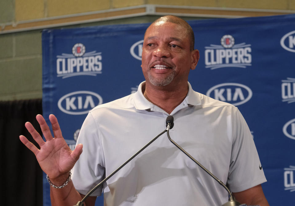 From left, Los Angeles Clippers head coach Doc Rivers introduces Paul George and Kawhi Leonard at a press conference at the Green Meadows Recreation Center in Los Angeles, Wednesday, July 23, 2019. (AP Photo/Ringo H.W. Chiu)