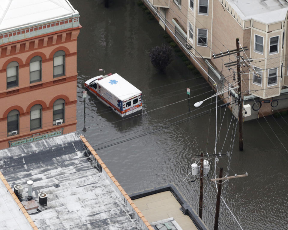 An ambulance is submerged in floodwaters in the wake of superstorm Sandy on Tuesday, Oct. 30, 2012, in Hoboken, N.J. Sandy, the storm that made landfall Monday, caused multiple fatalities, halted mass transit and cut power to more than 6 million homes and businesses. (AP Photo/Mike Groll)