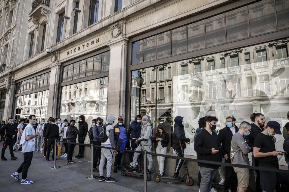 People queue outside the Niketown shop in London, Monday, June 15, 2020. After three months of being closed under coronavirus restrictions, shops selling fashion, toys and other non-essential goods are being allowed to reopen across England for the first time since the country went into lockdown in March.(AP Photo/Matt Dunham)