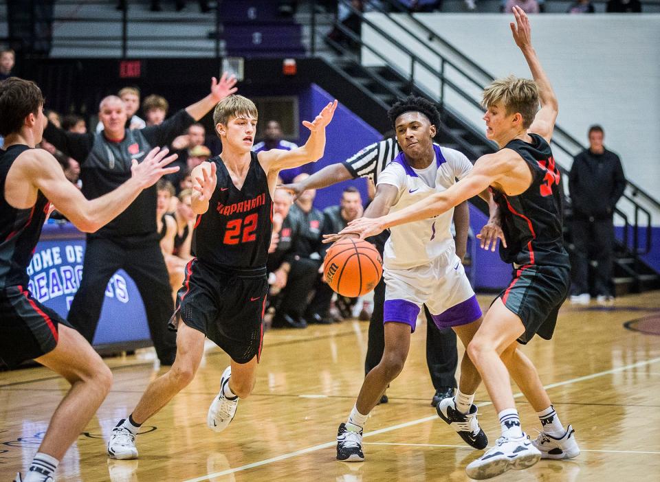 Muncie Central boys basketball's Daniel Harris gets swarmed by Wapahani defenders at the Muncie Fieldhouse during their game Saturday, Nov. 27, 2021.