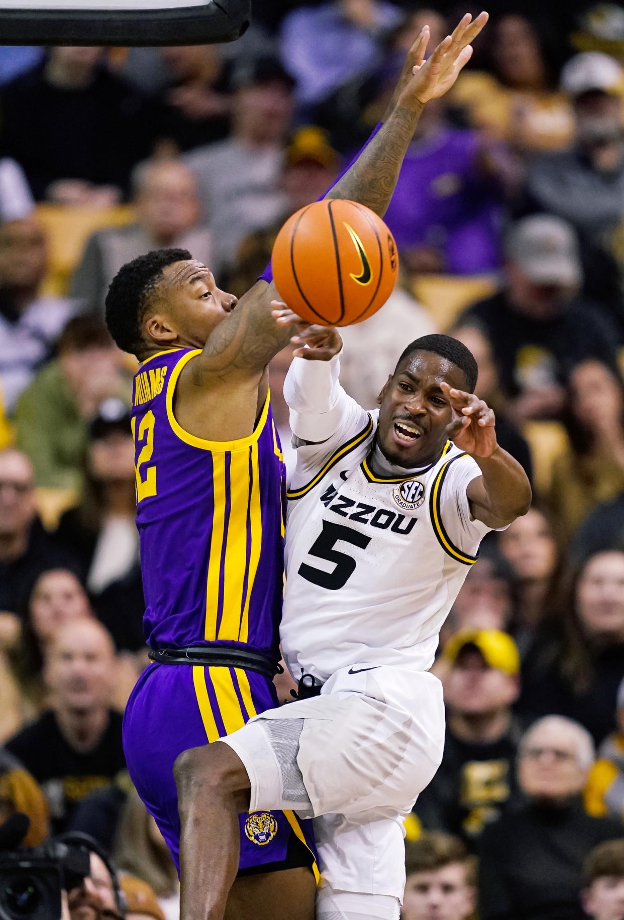 Feb 1, 2023; Columbia, Missouri, USA; Missouri Tigers guard D'Moi Hodge (5) passes the ball as LSU Tigers forward KJ Williams (12) defends during the second half at Mizzou Arena. Mandatory Credit: Jay Biggerstaff-USA TODAY Sports