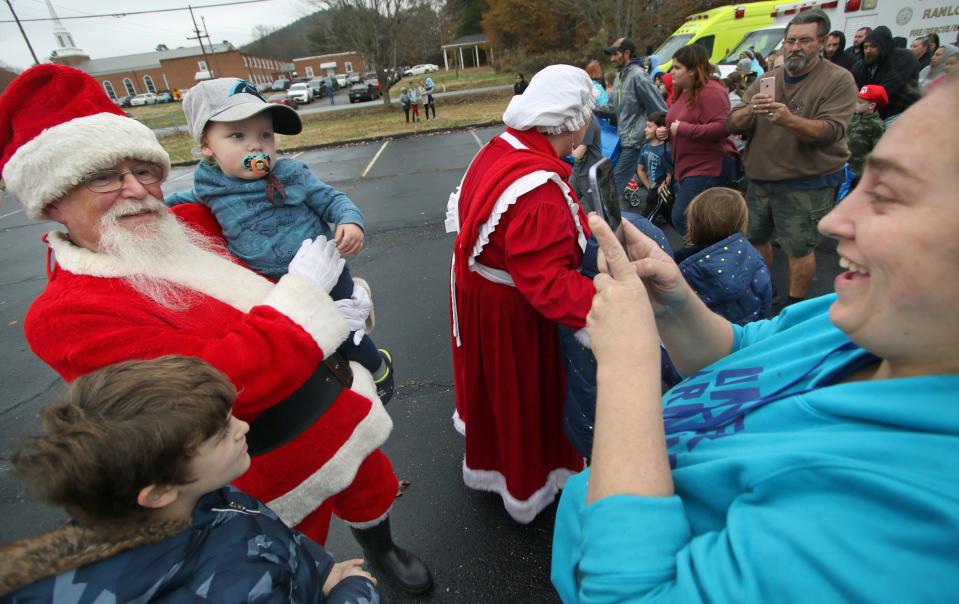 April Stiles takes a photo of 2-year-old Declan Galloway being held by Santa during the 27th annual Gaston County Toy Run for Kids which kicked off Saturday morning, Dec. 3, 2022, at the Ranlo Church of God.