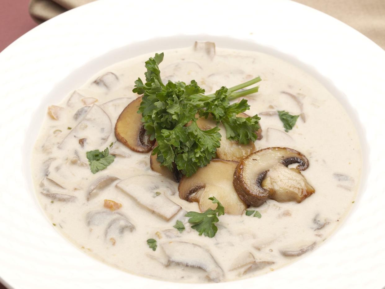 Bowl of Homemade Cream of Mushroom Soup garnished with sauteed Crimini Mushrooms