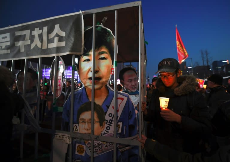 A poster shows Park Geun-Hye behind bars, at a rally in Seoul on March 11, 2017