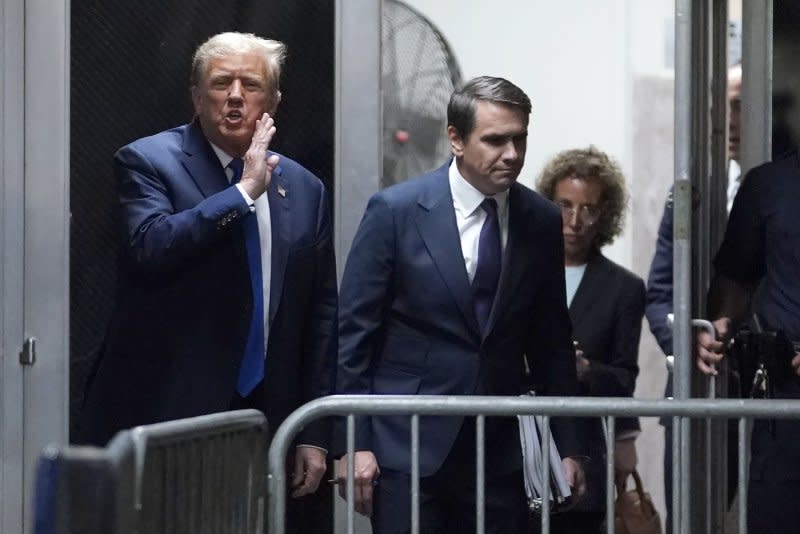At Manhattan Criminal Court in New York City on Thursday, former U.S. President Donald Trump (L), with his attorney Todd Blanche (C), returns from lunch break as he attends his trial for allegedly covering up hush-money payments linked to extramarital affairs. Pool Photo by Timothy A. Clary/UPI