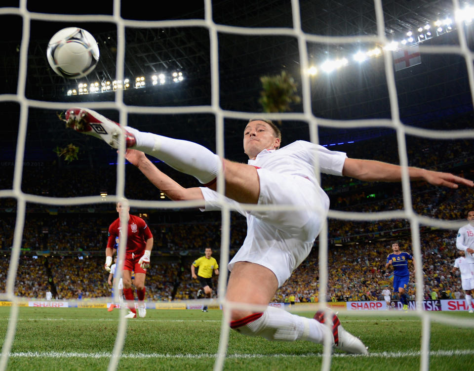 DONETSK, UKRAINE - JUNE 19: John Terry of England clears an effort from Marko Devic of Ukraine off the line during the UEFA EURO 2012 group D match between England and Ukraine at Donbass Arena on June 19, 2012 in Donetsk, Ukraine. (Photo by Laurence Griffiths/Getty Images)