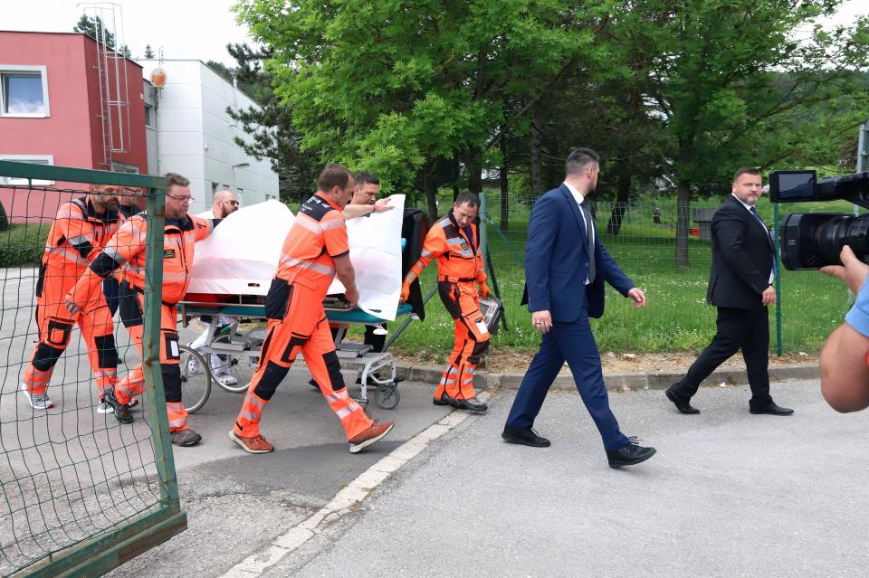Slovak prime minister Robert Fico is wheeled into hospital in Banska Bystrica after being wounded in a shooting in Handlova (AP)