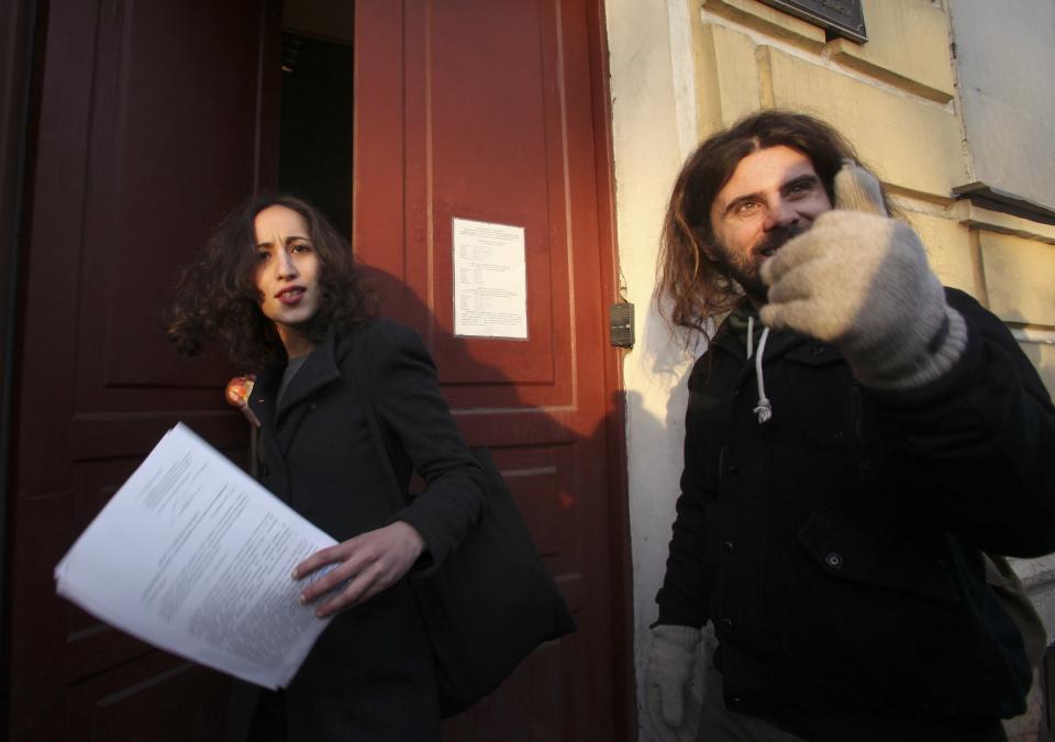 Greenpeace activist Faiza Oulahsen holds papers certifying the termination of prosecution after walking out of the offices of the Federal Migration Service Department in St. Petersburg