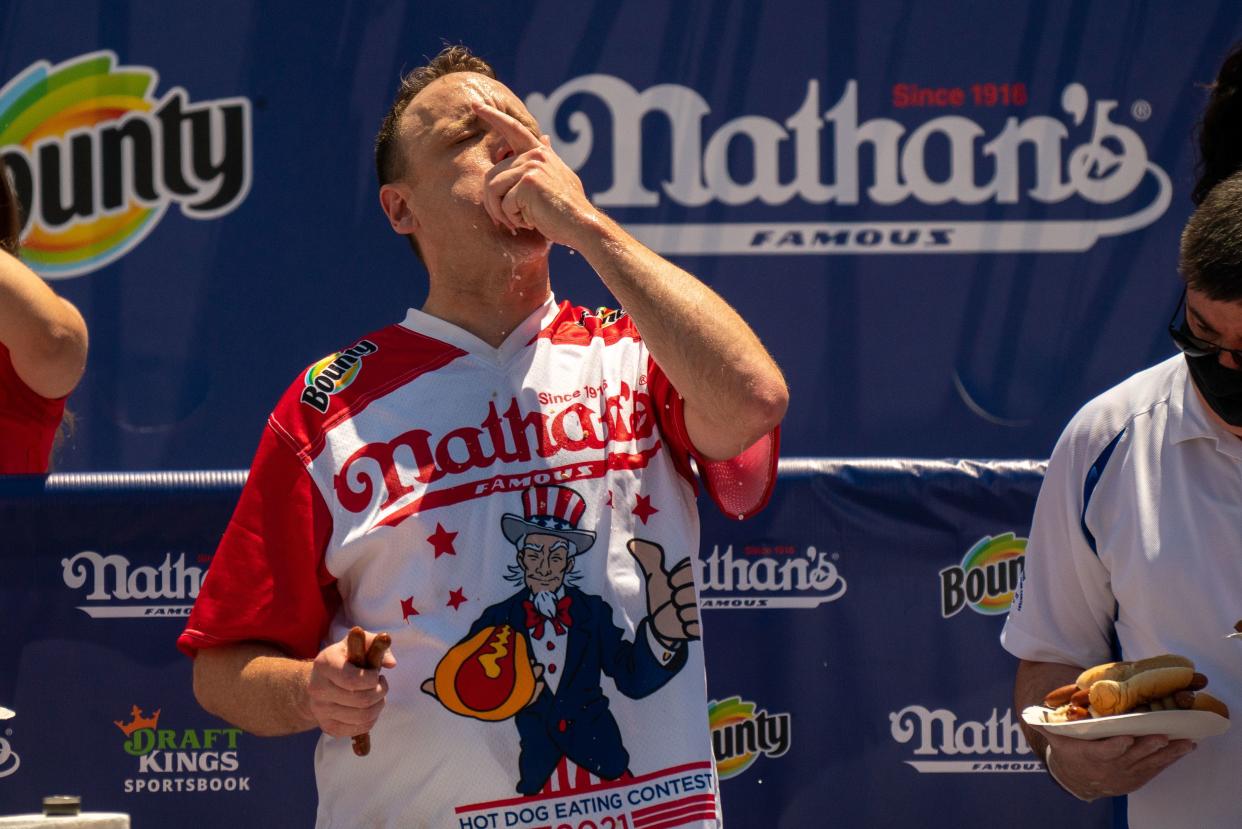 Competitive eating champion Joey "Jaws" Chestnut wins the 2021 Nathan's Famous 4th Of July International Hot Dog Eating Contest with 76 hot dogs, breaking his personal best record of 75, at Coney Island on July 4, 2021, in New York City.