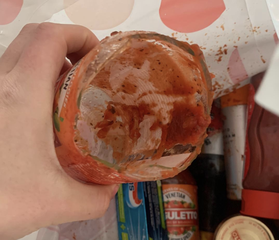 This jar of pasta sauce smashed and caused the woman's groceries and front porch to be coated in sauce. Source: Facebook