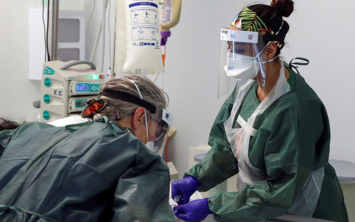 FILE PHOTO: Nurses care for a patient in an Intensive Care ward treating victims of the coronavirus disease (COVID-19) in Frimley Park Hospital in Surrey, Britain, May 22, 2020. Picture taken May 22, 2020. Steve Parsons/Pool via REUTERS/File Photo - Steve Parsons/REUTERS