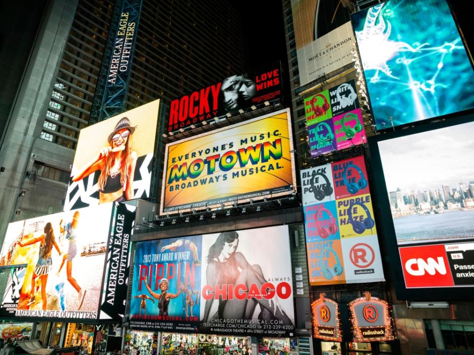 Broadway theater billboards in Times Square at night, New York