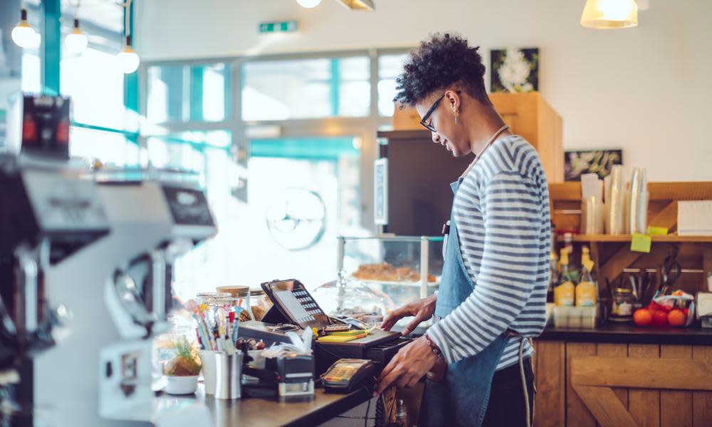 Young barista is working in a café