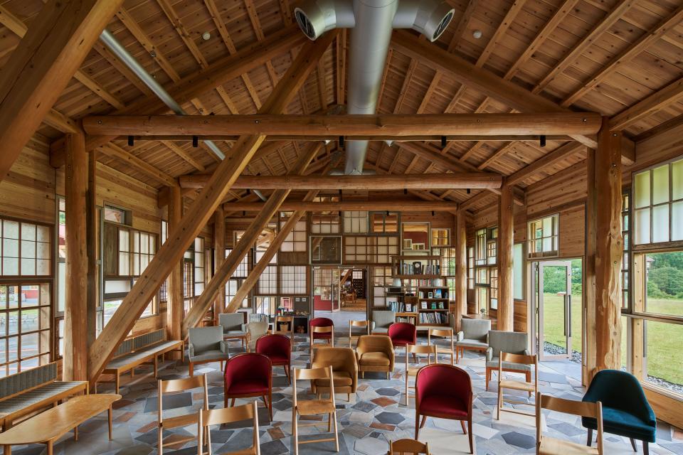 The inside of a building is full of tables and chairs