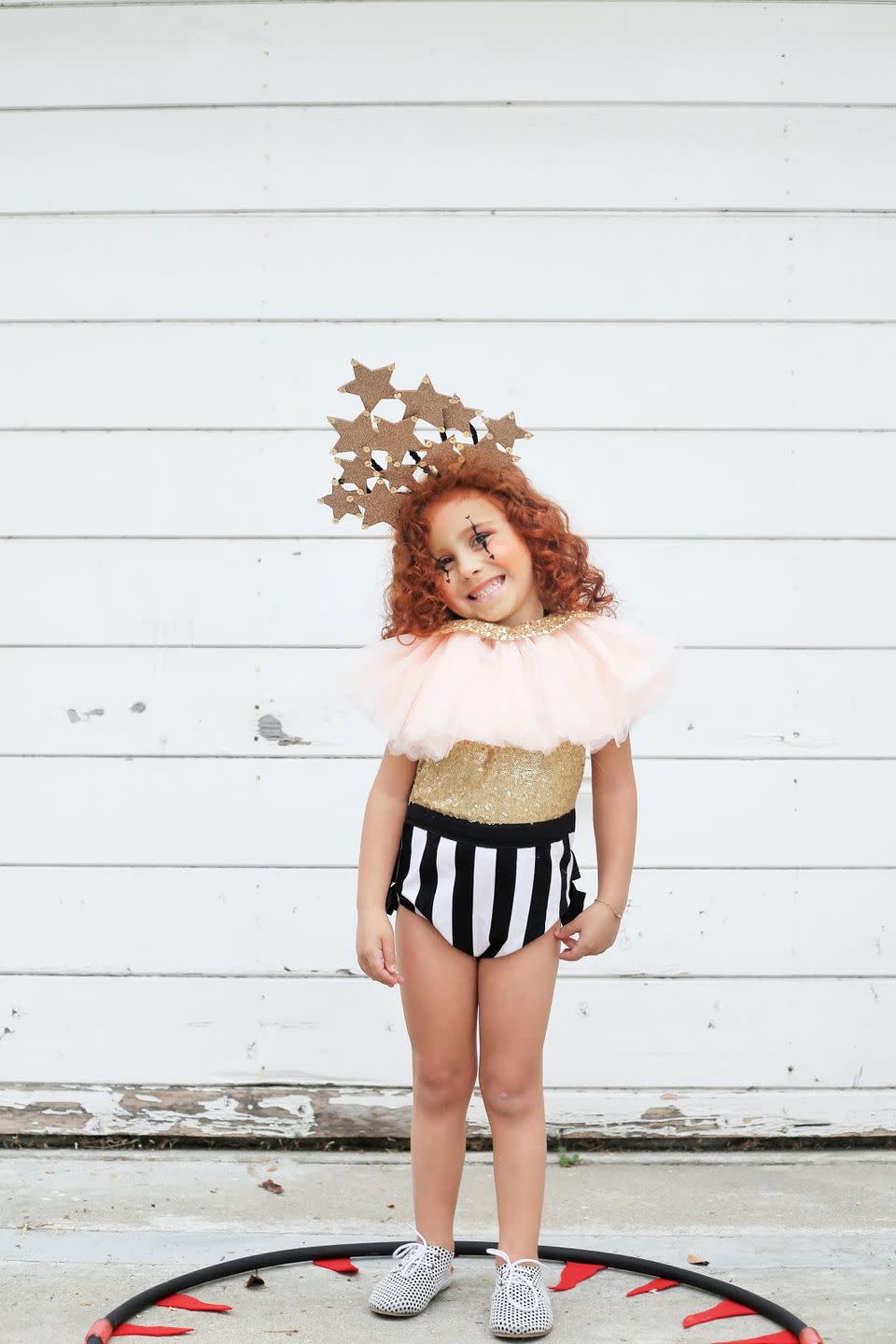 <p>Your gorgeous gal will sparkle under the spotlight in this adorable DIY outfit, which features a handmade headband and touch of face paint. </p><p><strong>See more at <a href="http://www.alittlejandk.com/2017/10/step-right-up.html" rel="nofollow noopener" target="_blank" data-ylk="slk:a little j+k;elm:context_link;itc:0;sec:content-canvas" class="link ">a little j+k</a>. </strong></p><p><a class="link " href="https://www.amazon.com/Spectra-PAC91780-Glitter-Gold-lb/dp/B00006IAHH?tag=syn-yahoo-20&ascsubtag=%5Bartid%7C10050.g.29402076%5Bsrc%7Cyahoo-us" rel="nofollow noopener" target="_blank" data-ylk="slk:SHOP GLITTER;elm:context_link;itc:0;sec:content-canvas">SHOP GLITTER</a></p>