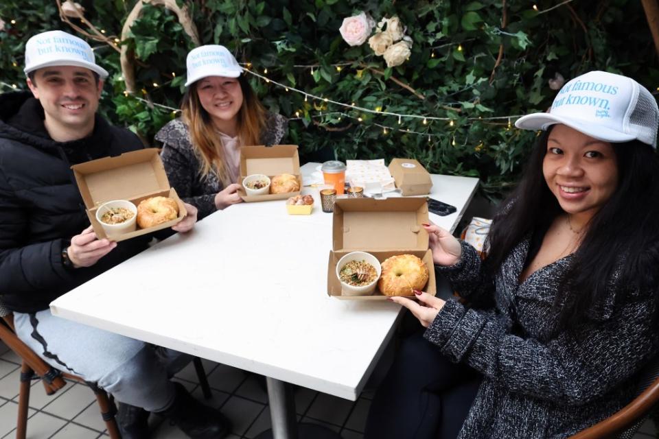 Corinne Kwan, right, her fiancée Jimmy Moscoso, and her sister Kaitlyn Kwan lined up for the escargot bagel special on Saturday. William Farrington