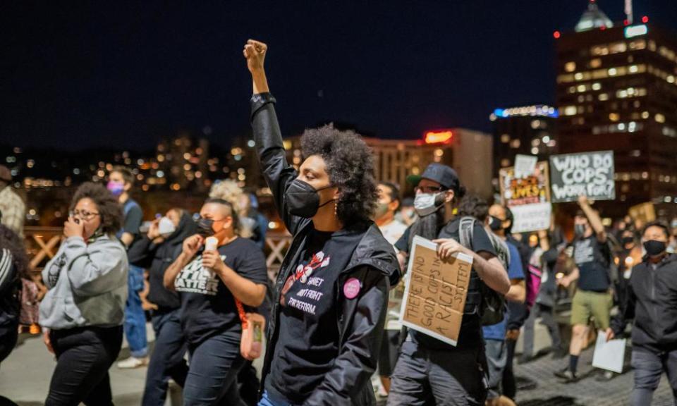 Protesters march along the Hawthorne Bridge after the police shooting of Robert Delgado.