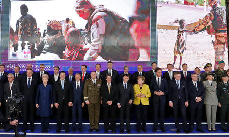 EU leaders take part in a group photo on the launching of the Permanent Structured Cooperation, or PESCO, a pact between 25 EU governments to fund, develop and deploy armed forces together, during a EU summit in Brussels, Belgium, December 14, 2017. REUTERS/Yves Herman