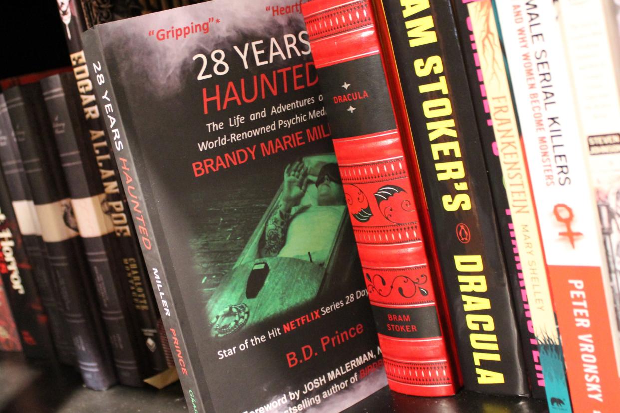 Nestled between books by Edgar Allan Poe and Bram Stoker's "Dracula," Bryan Prince's latest book, “28 Years Haunted The Life and Adventures of World-Renowned Psychic Medium Brandy Marie Miller,” can be found at Nocturnal's lending library.