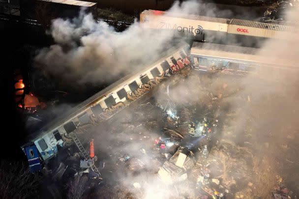 PHOTO: Smoke rises from trains as firefighters and rescuers operate after a collision near Larissa city, Greece, on March 1, 2023. (Vaggelis Kousioras/AP)