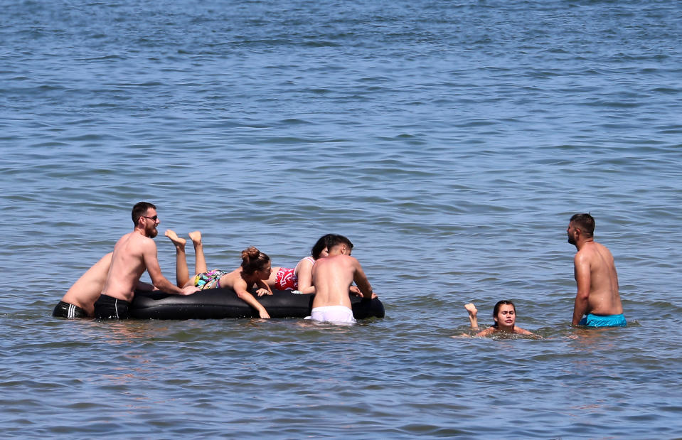 People enjoy the sea in Margate, Kent, as they cool off from soaring temperatures.