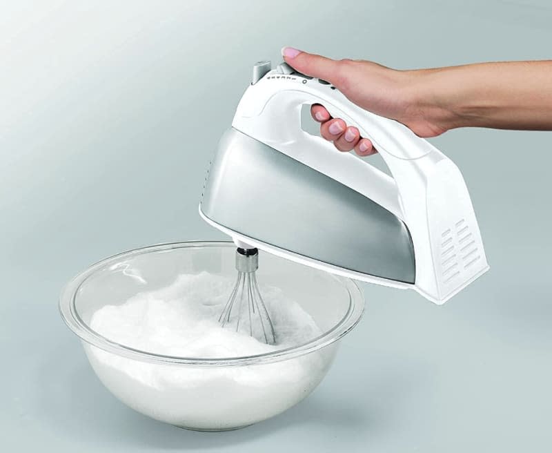 person using white hand mixer