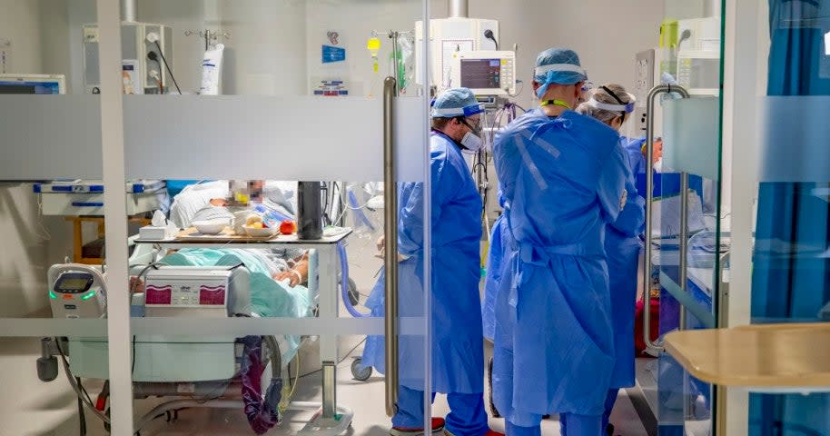 Health workers wearing full personal protective equipment (PPE) tend to a patient on the intensive care unit (ICU) at Whiston Hospital in Merseyside as they continue deal with the increasing number of coronavirus patients on Tuesday, 20 October 2020 (Peter Byrne/PA Wire)