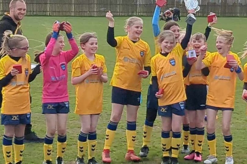 The under-10s Woodlands FC team celebrate winning the Vase trophy -Credit:Woodlands FC