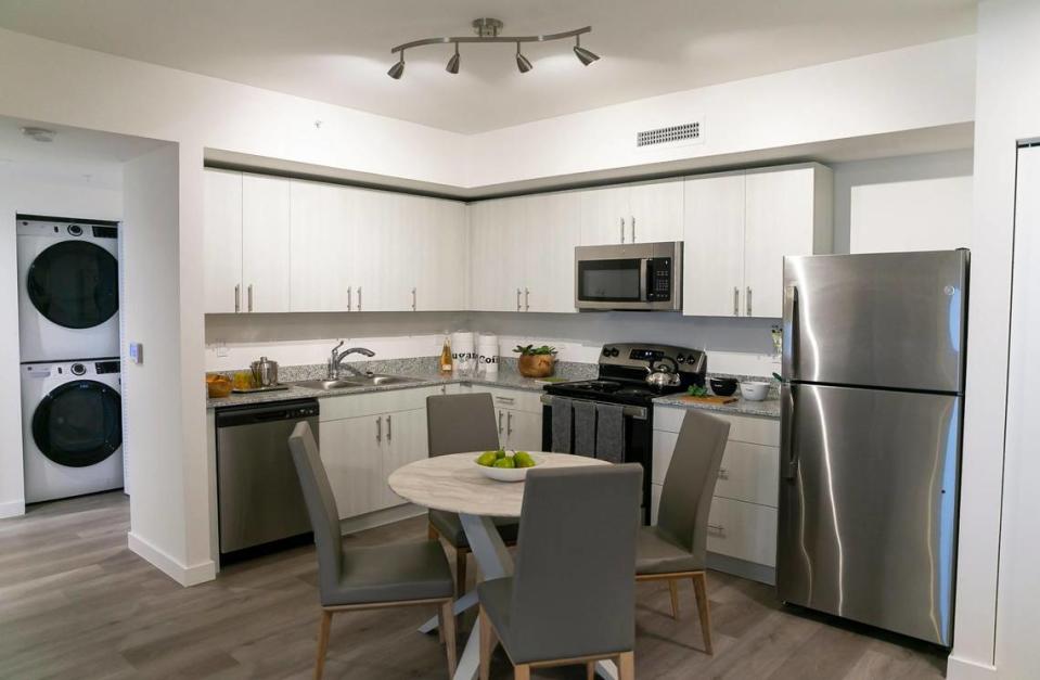 All residences have the same finishes and appliances — salt-and-pepper colored granite kitchen counters, General Electric stainless steal appliances and hurricane impact windows. Above: Inside one of the units at Harmony at Liberty Square.
