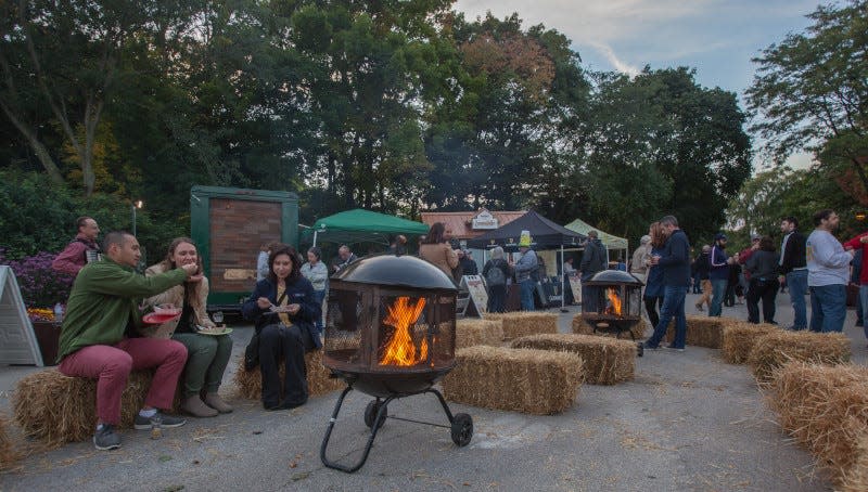 Revelers gather near campfires at Zoo Brew, held at the Milwaukee County Zoo.