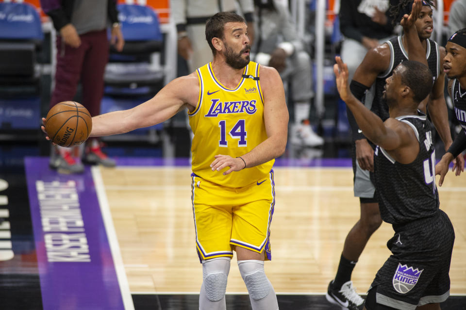 Los Angeles Lakers center Marc Gasol (14) looks to make a pass as he is defended by Sacramento Kings forward Harrison Barnes (40) during the first quarter of an NBA basketball game in Sacramento, Calif., Friday, April 2, 2021. (AP Photo/Hector Amezcua)