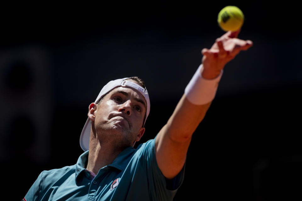 United States' John Isner serves to Austria's Dominic Thiem during their match at the Mutua Madrid Open tennis tournament in Madrid, Spain, Friday, May 7, 2021. (AP Photo/Bernat Armangue)