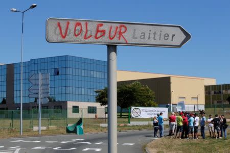 French dairy farmers from the FNSEA union gather as they block the round-about access to the Lactalis plant, with a sign that reads "Thief", as they protest against the price of milk in Laval, France, August 23, 2016. REUTERS/Stephane Mahe