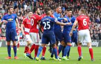 <p>United and Boro players come together after a heated exchange </p>